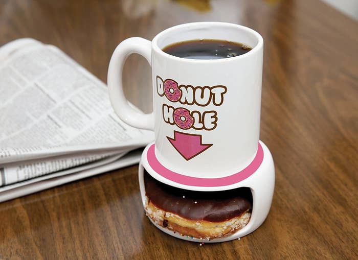 A donut in the bottom of the mug