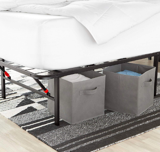 Gray foldable storage cubes under a big bed
