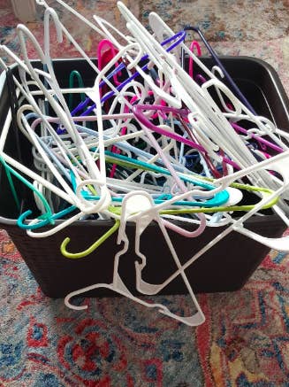 Reviewer's pile of messy hangers before using the hanger stacker