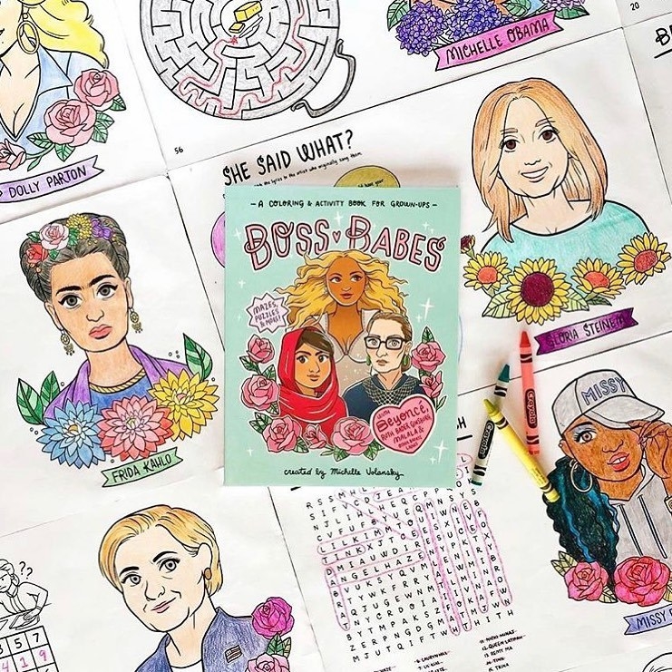 An activity book on a pile of colouring book sheets