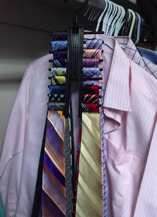 Reviewer shows tie rack holder with different colored ties in their closet