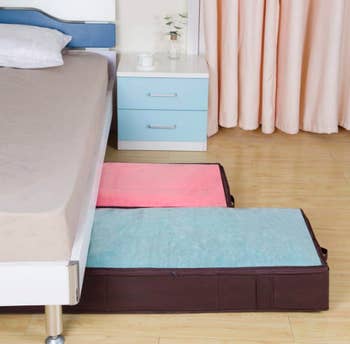 Underbed storage bags with linens under a bed