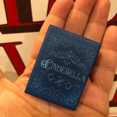 the tiny Cinderella book in reviewer's palm 