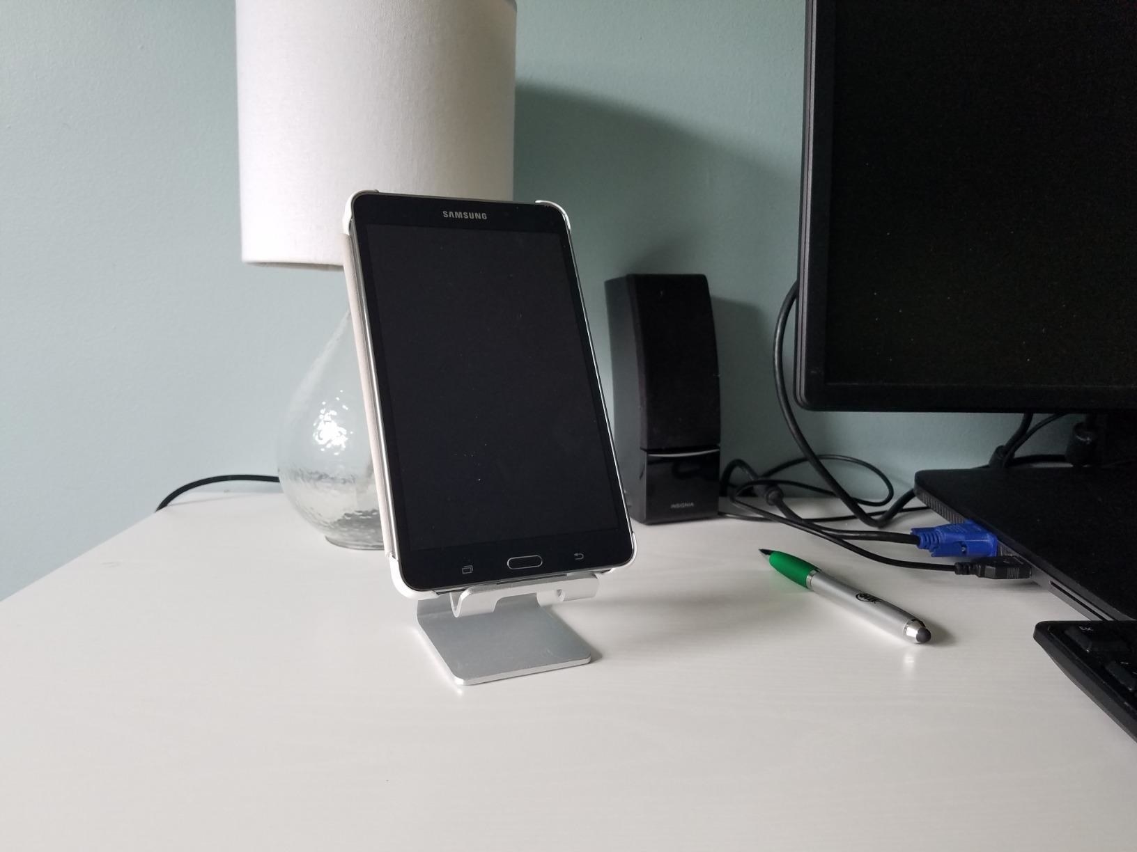 reviewer&#x27;s phone on a silver stand 