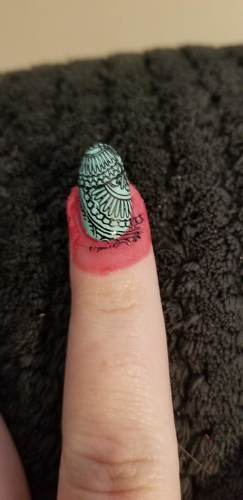 The latex paint guard around a nail with mess from a stamp on it