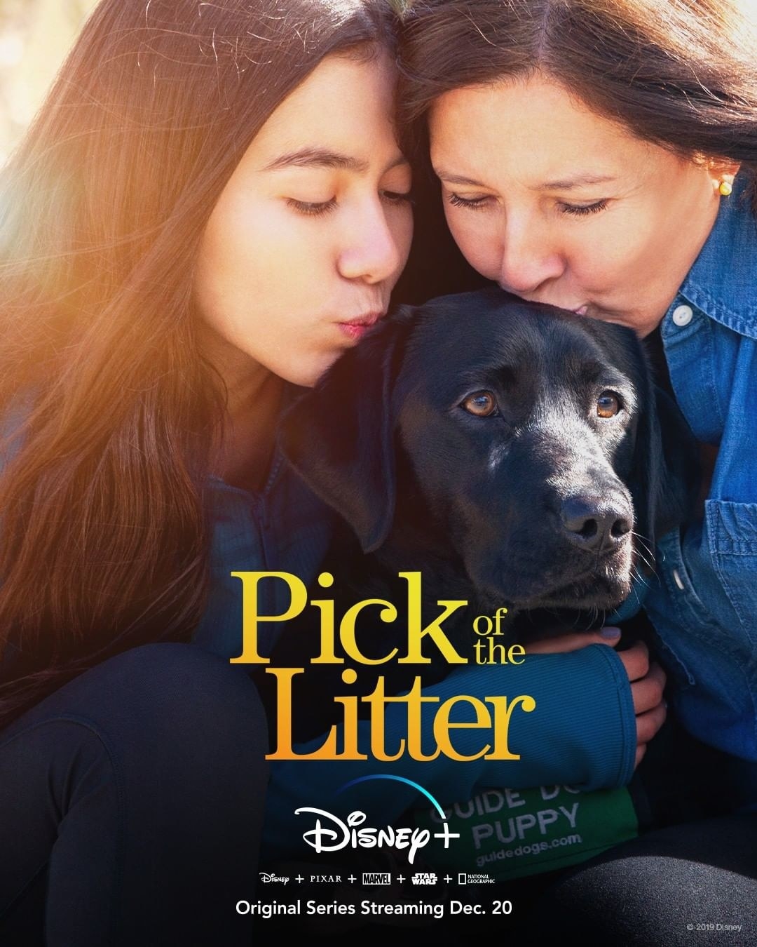 a mom and daughter cuddling their black lab