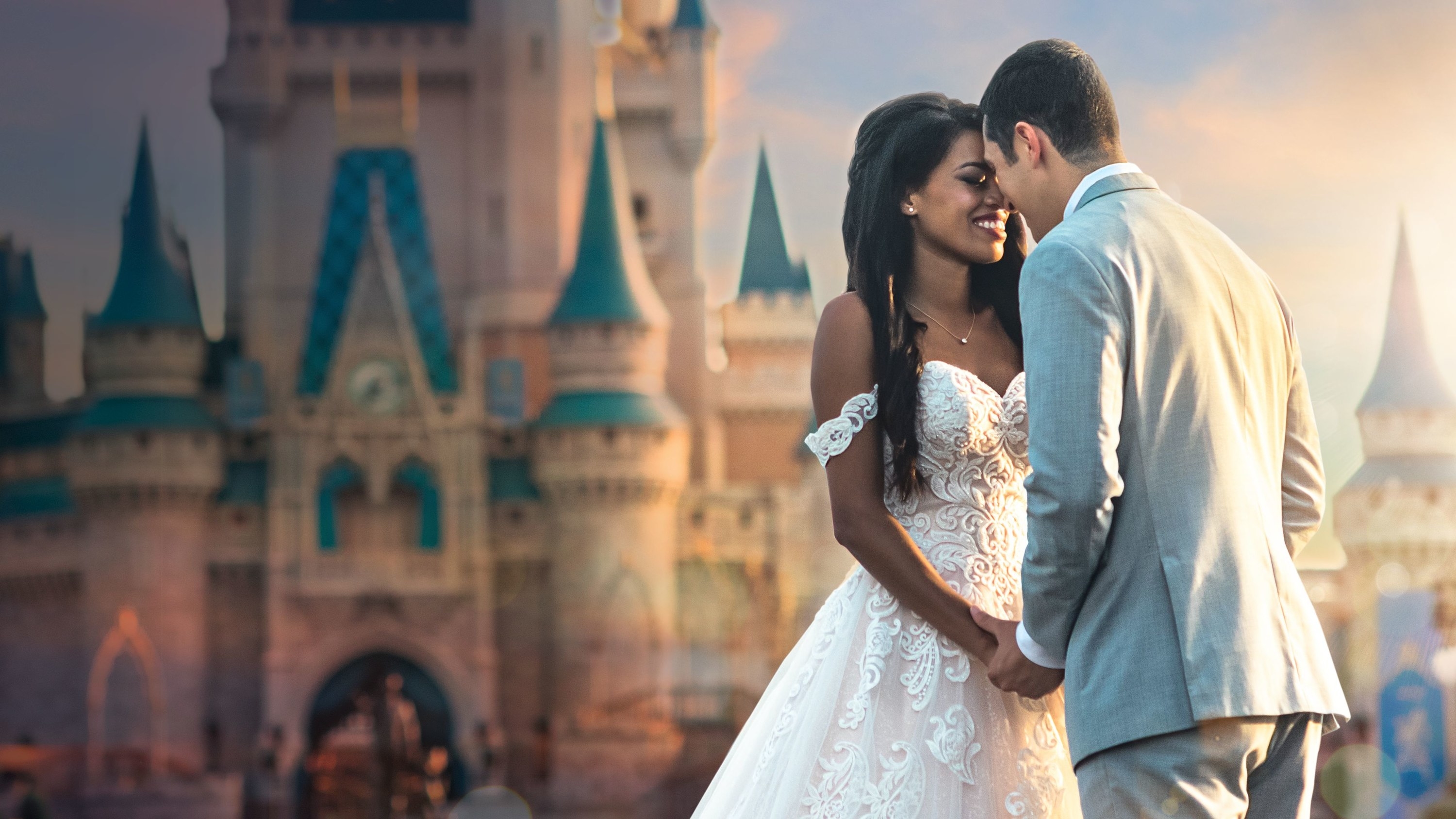 a couple dress for their wedding in front of cinderella castle