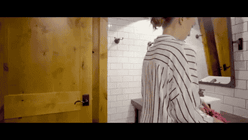 A model opening the bag so it lays flat with all the makeup in it