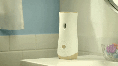 A white glade scent dispenser letting out a scent 