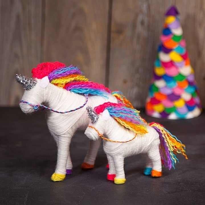 The finished product, covered in yarn with a rainbow colored mane 