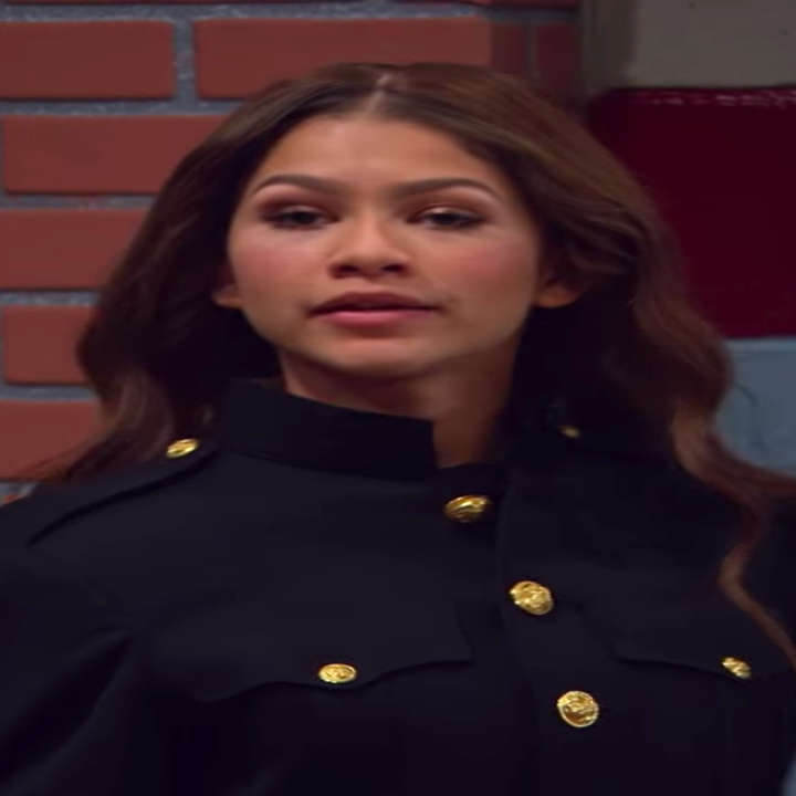 KC with glittery eyeshadow and curled hair