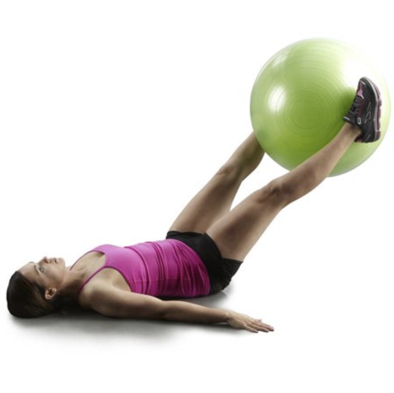 Model doing leg raises with the green medicine ball