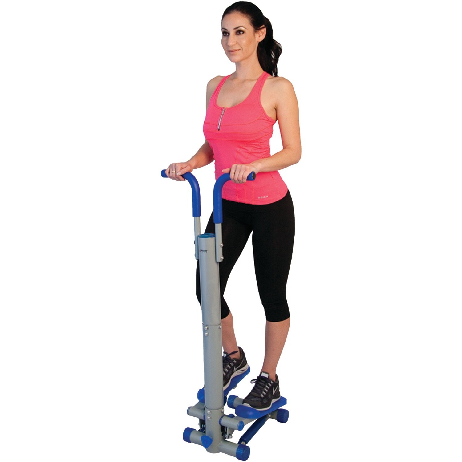 Model standing and using the mini stepper while balancing with its handles 