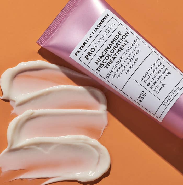 A pink tube that says &quot;Peter Thomas Roth PRO Strength Niacinamide Discoloration Treatment&quot; with a white-colored formula next to it