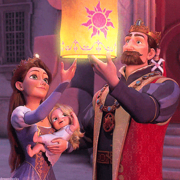 Rapunzel&#x27;s parents letting a lantern into the sky as they hold a baby version of her