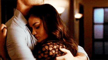 Aria pushing her face into Ezra&#x27;s chest