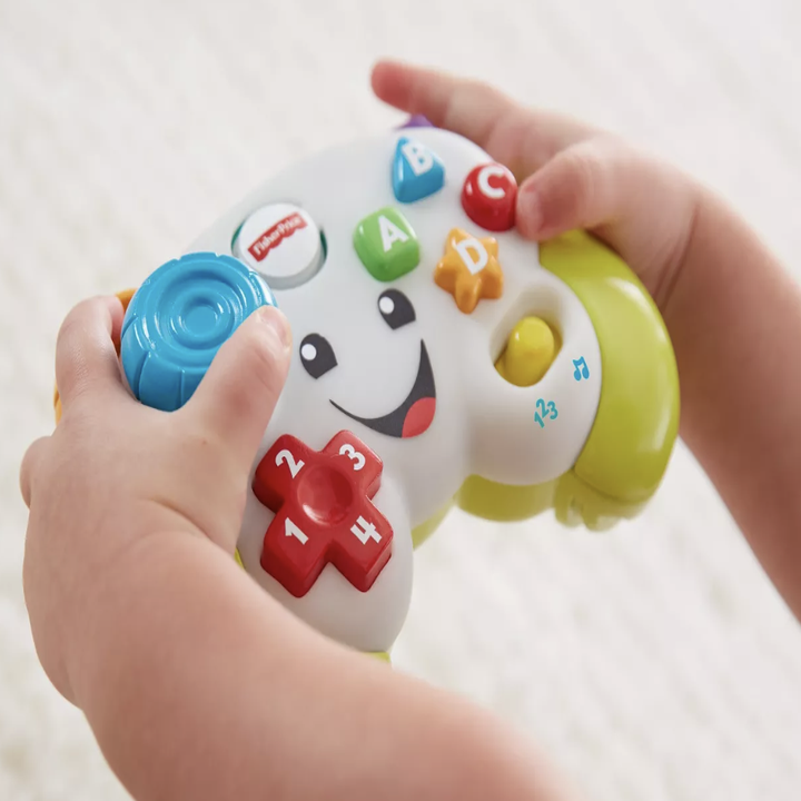 the white hand held video game controller toy