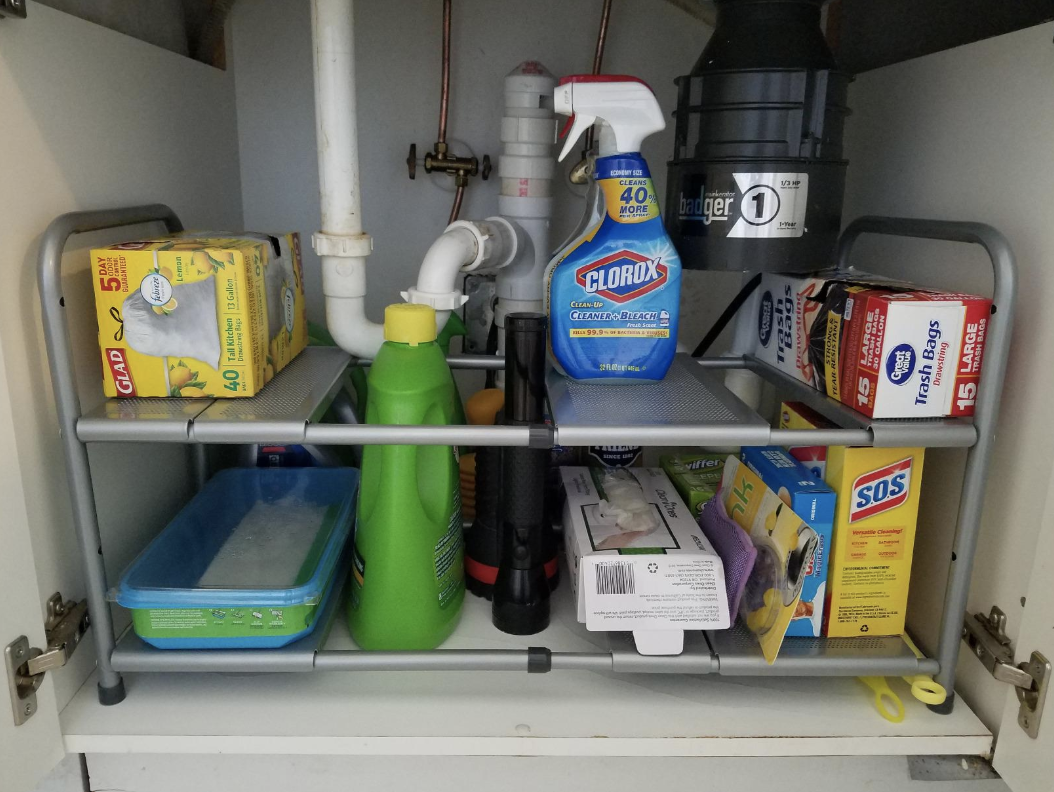 the shelf holding cleaning supplies