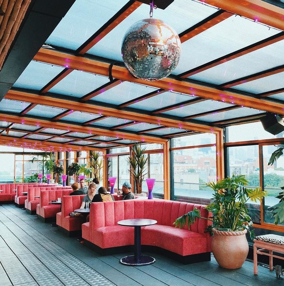 pink booth chairs in a rooftop bar