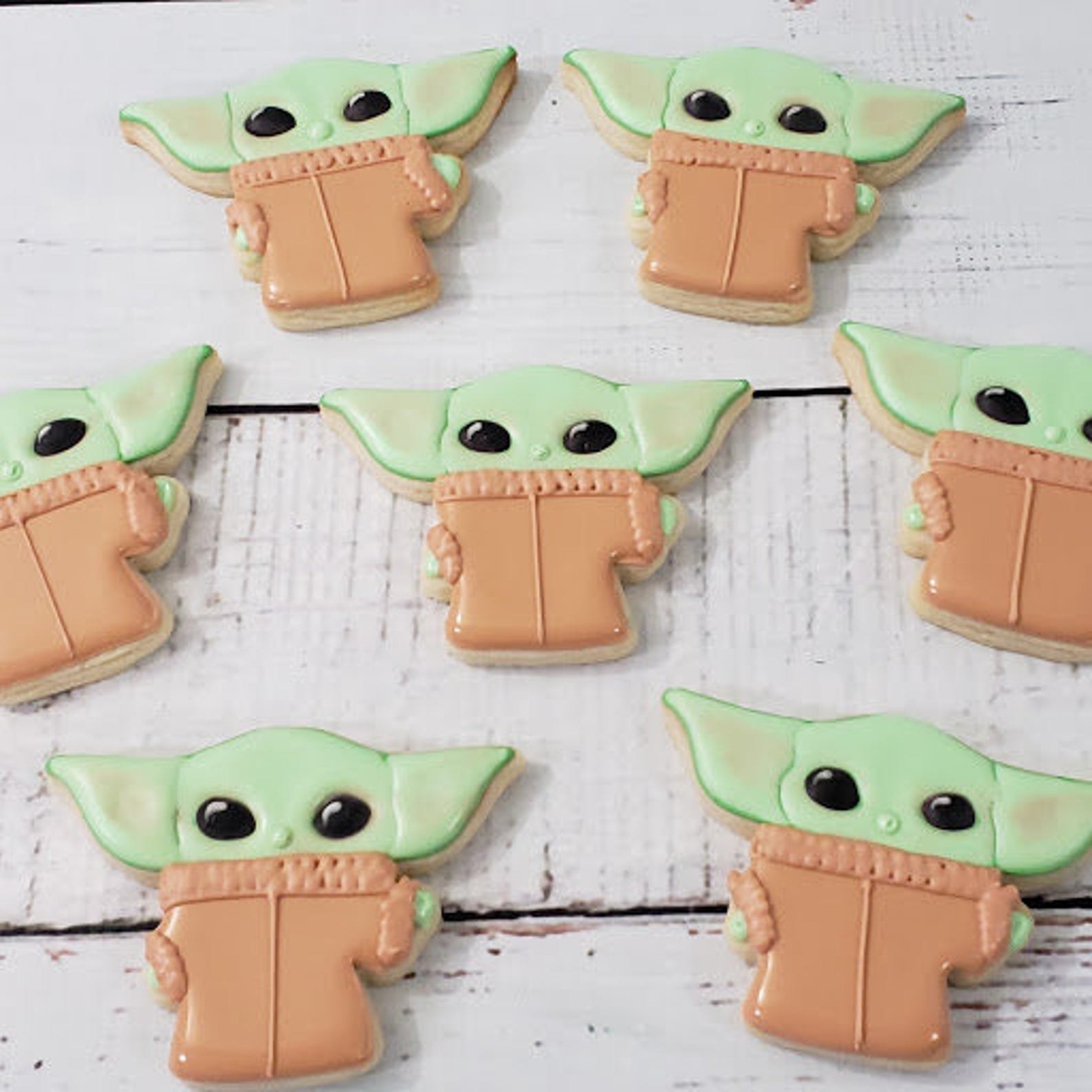 A bunch of Baby Yoda-shaped frosted cookies 