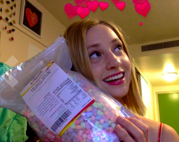 Reviewer holding up bag of marshmallows and smiling 