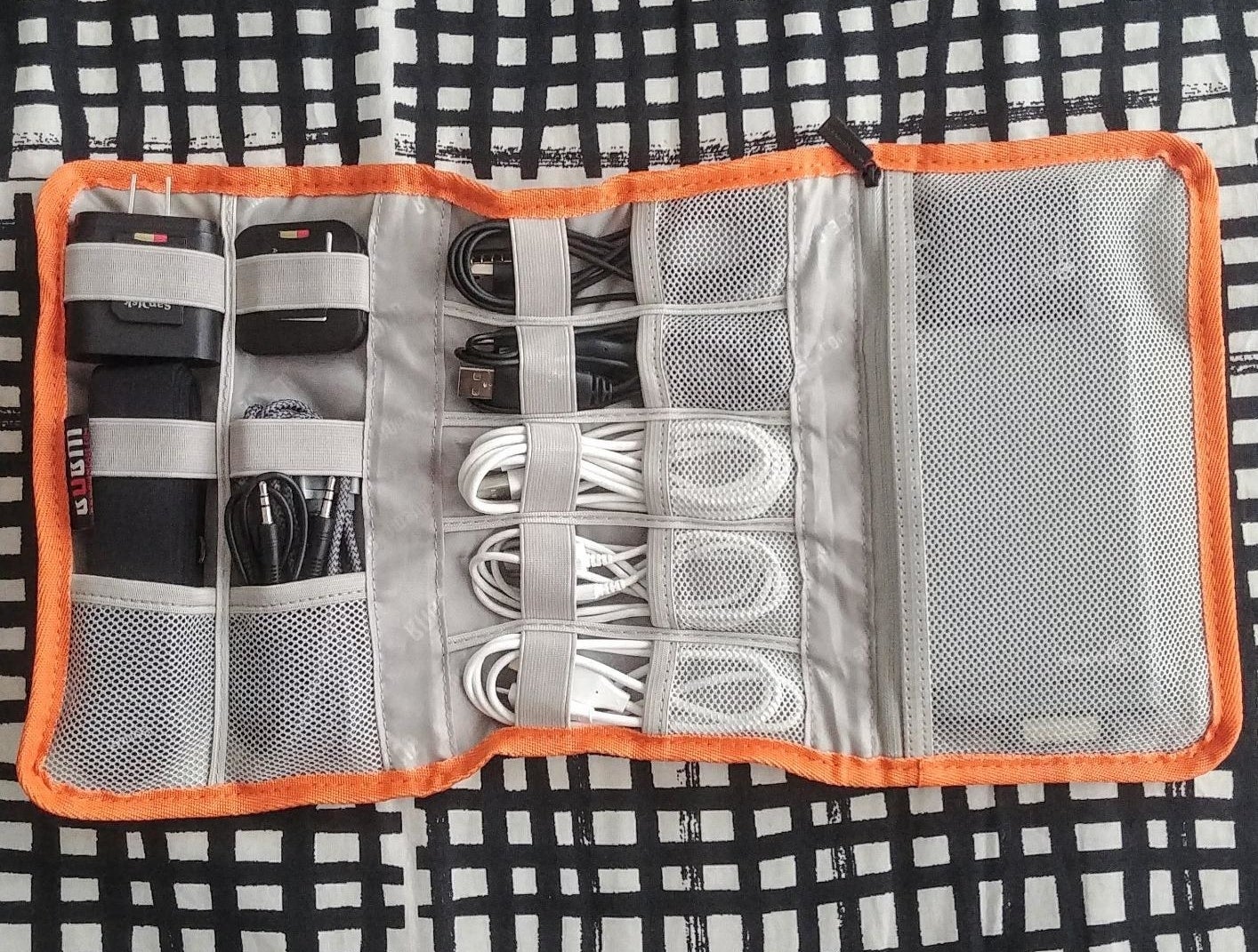 Reviewer photo of the organizer filled with cords and chargers