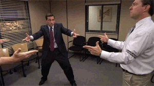 gif of Steve Carell, Rainn Wilson, and Ed Helms in the TV show &quot;The Office&quot; standing in a circle and pointing finger guns at each other