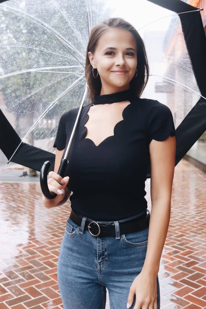A reviewer wearing the top in black with jeans 