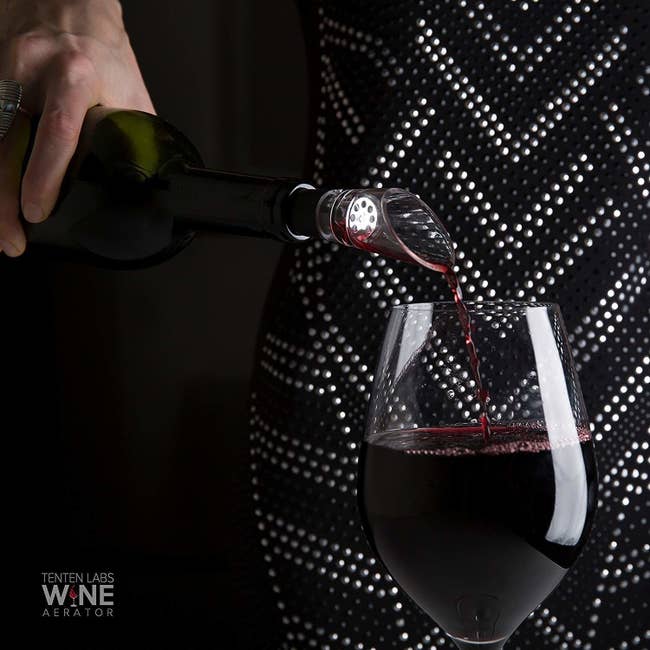 Model pouring wine with aerator attached to the lid 