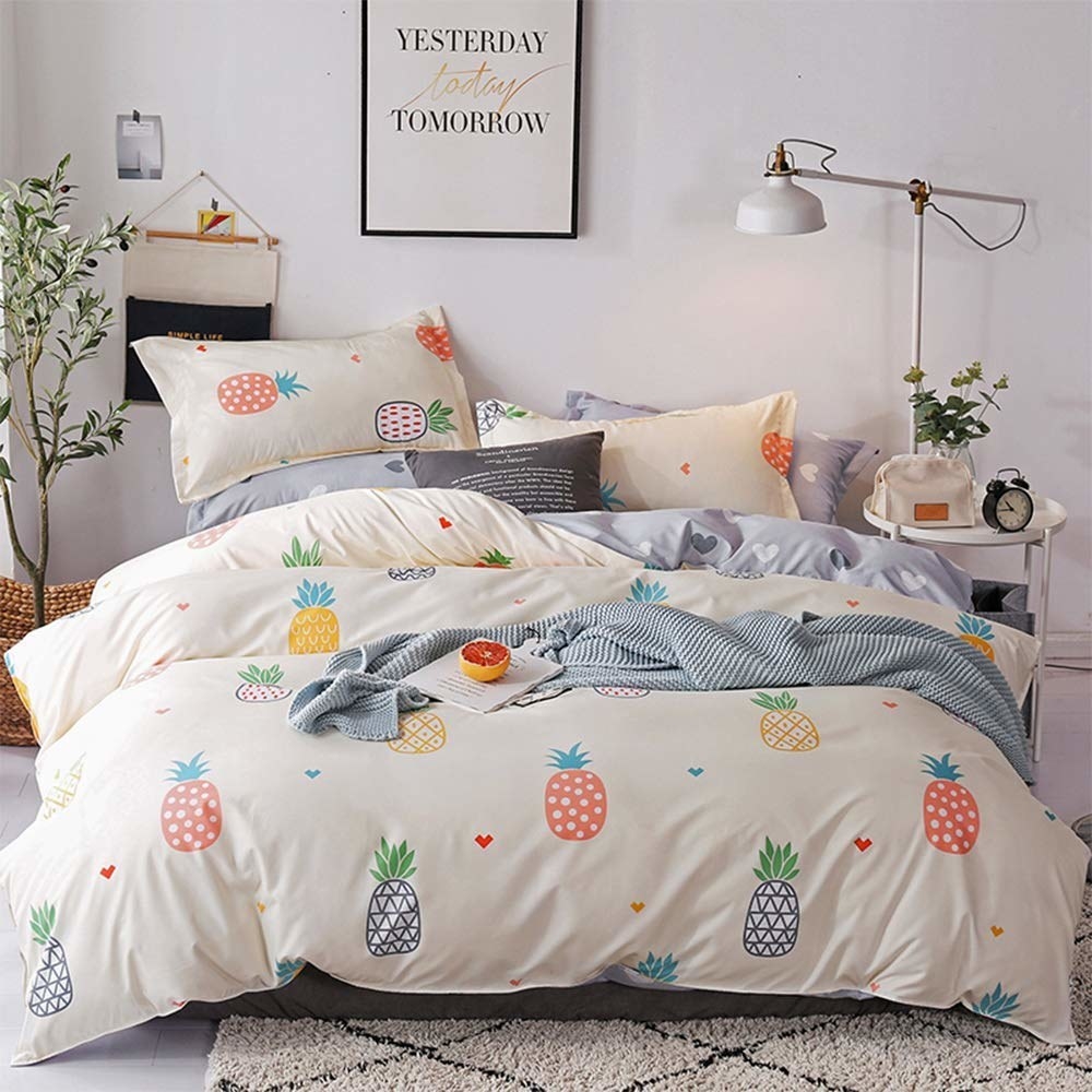 the white duvet set with different colored pineapples printed on it