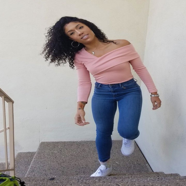 reviewer wearing the top in pink with jeans 