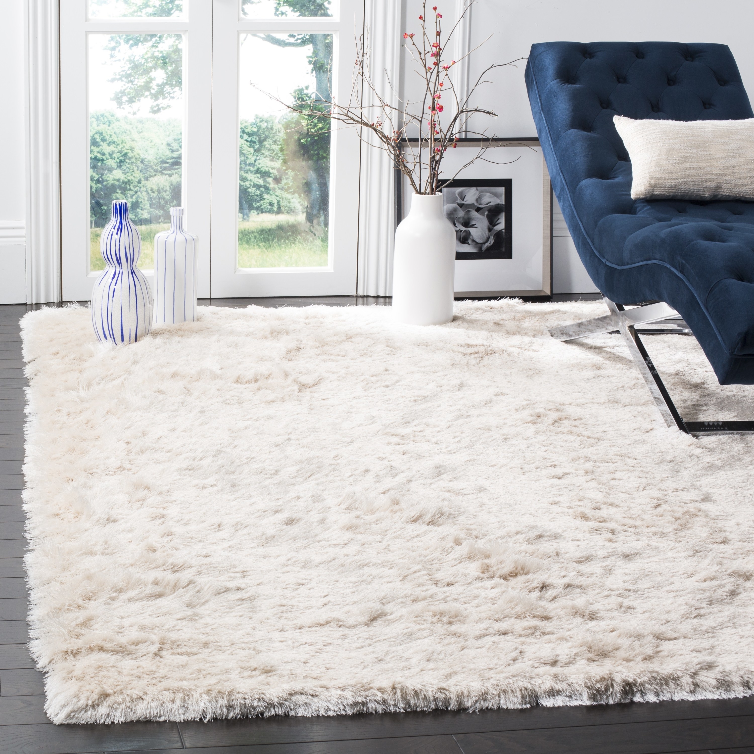 the white shag rug with a blue chair on it and other vases