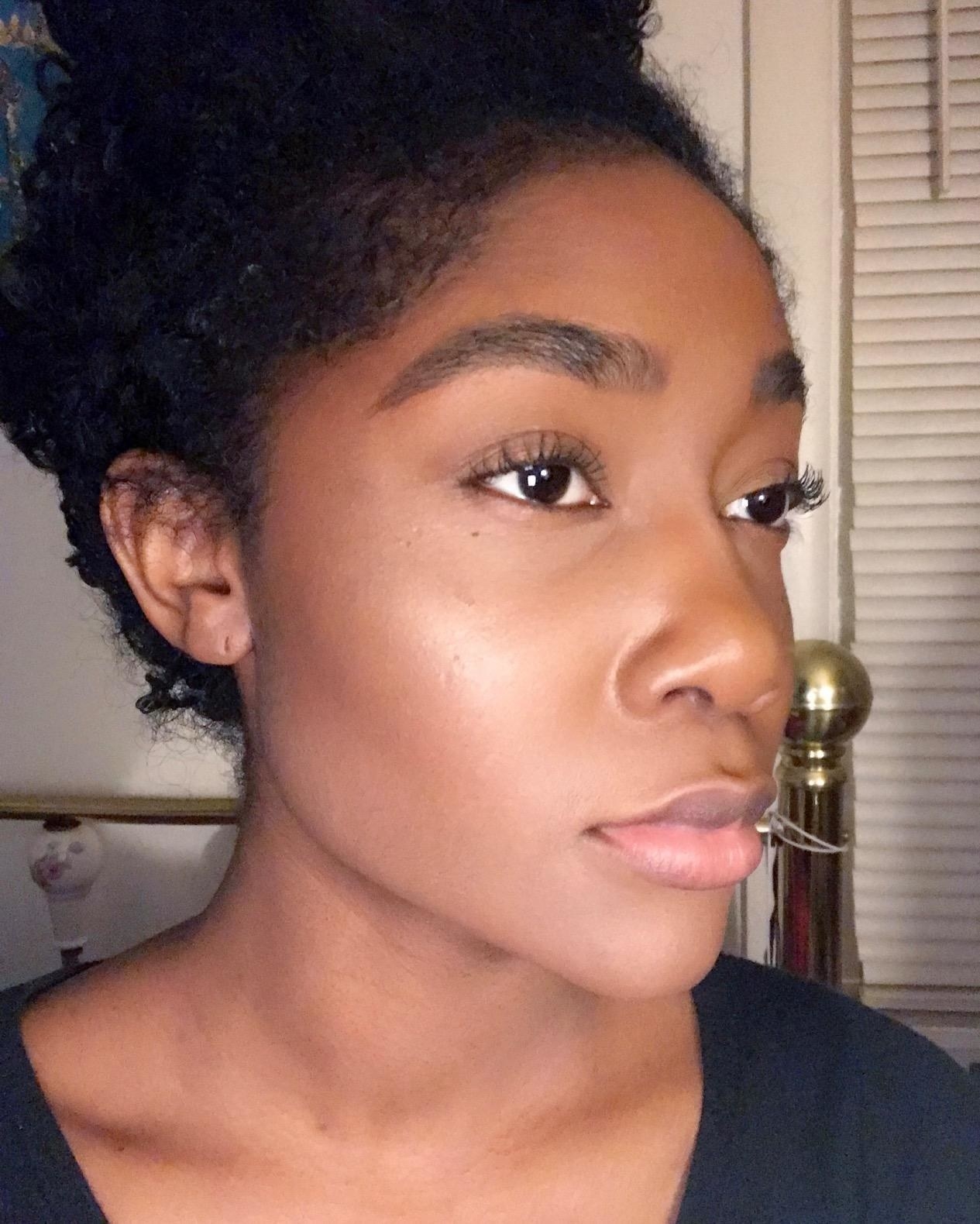 Reviewer with beautiful dark matte skin showing that the product doesn&#x27;t leave a white cast