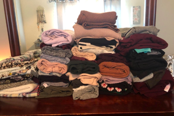 a reviewer's large stack of clothes