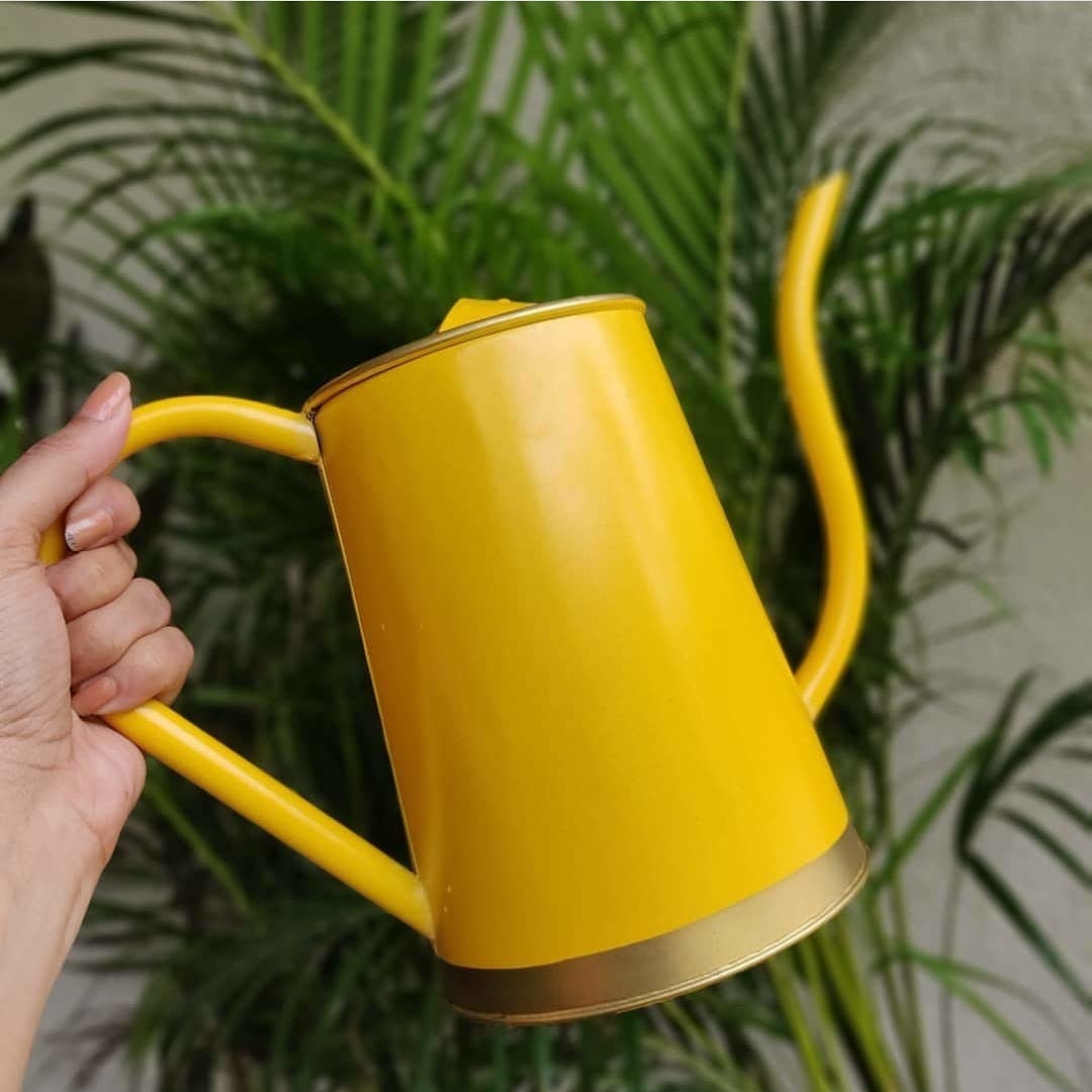 A bright yellow watering can.