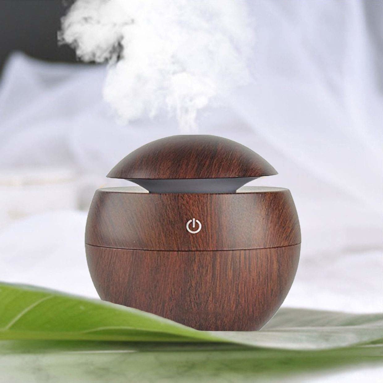 A brown diffuser on a table, releasing essential oils in the air 