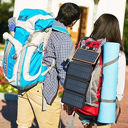 Two people walking together, with the solar power bank charging on one of their bags.