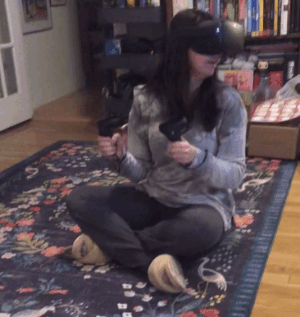a gif of someone playing with the oculus on their face