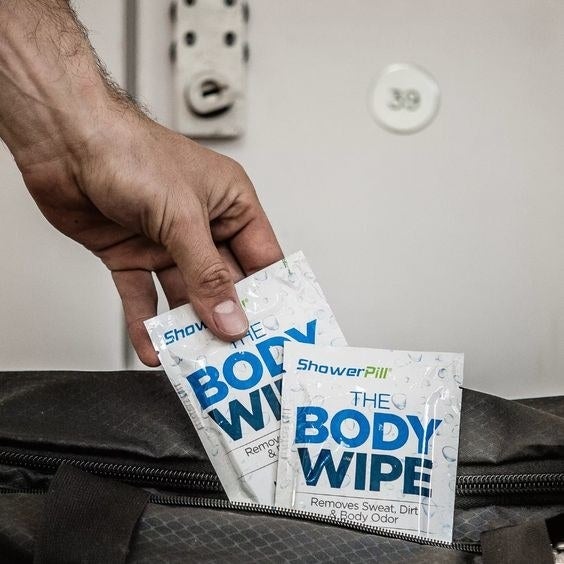 hand placing the body wipe in a gym bag