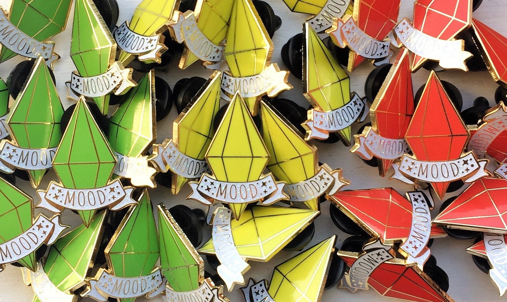 green, yellow, and red plumbob pins with the word "mood" written across them