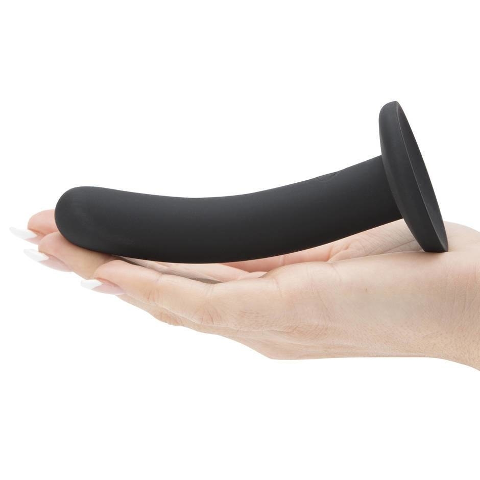 a hand holding the black smooth dildo 