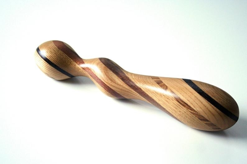 the smooth wooden toy with a flared base, curve in the middle, and rounded top