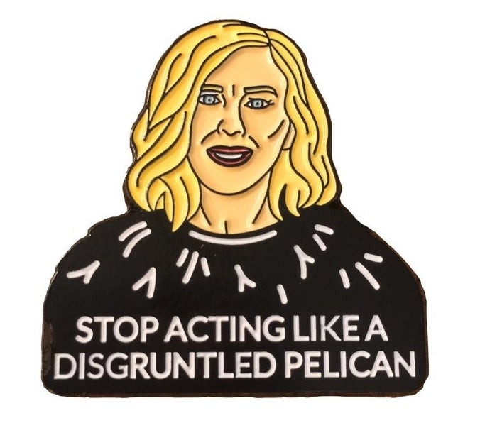 The pin of Moira&#x27;s face and the words &quot;Stop acting like a disgruntled pelican&quot;