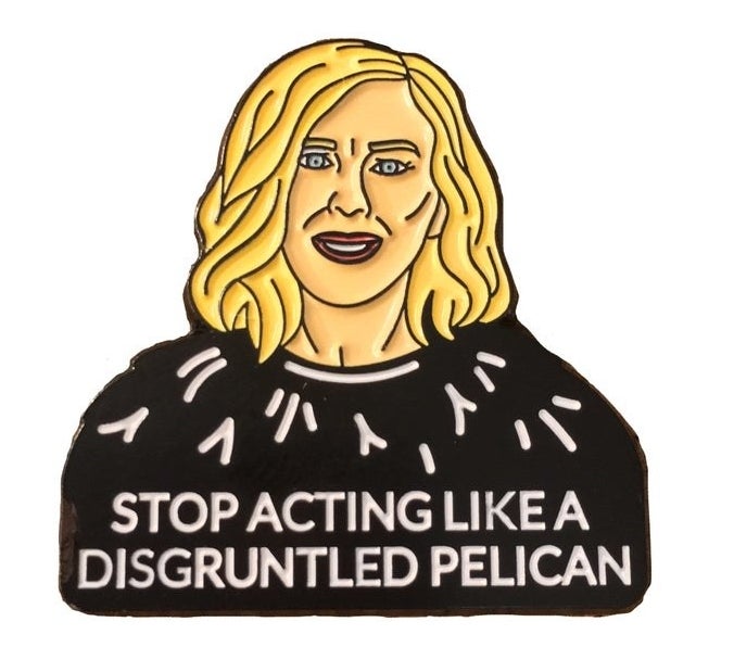 The pin of Moira&#x27;s face and the words &quot;Stop acting like a disgruntled pelican&quot;