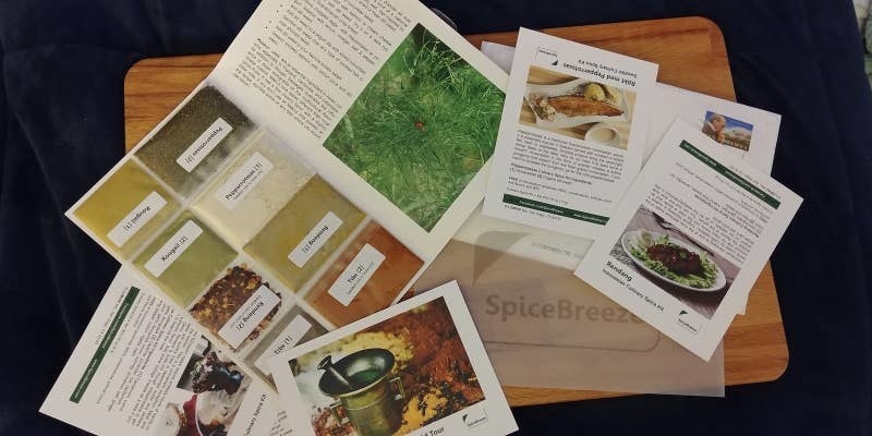 assorted information cards about spices and recipes on a cutting board