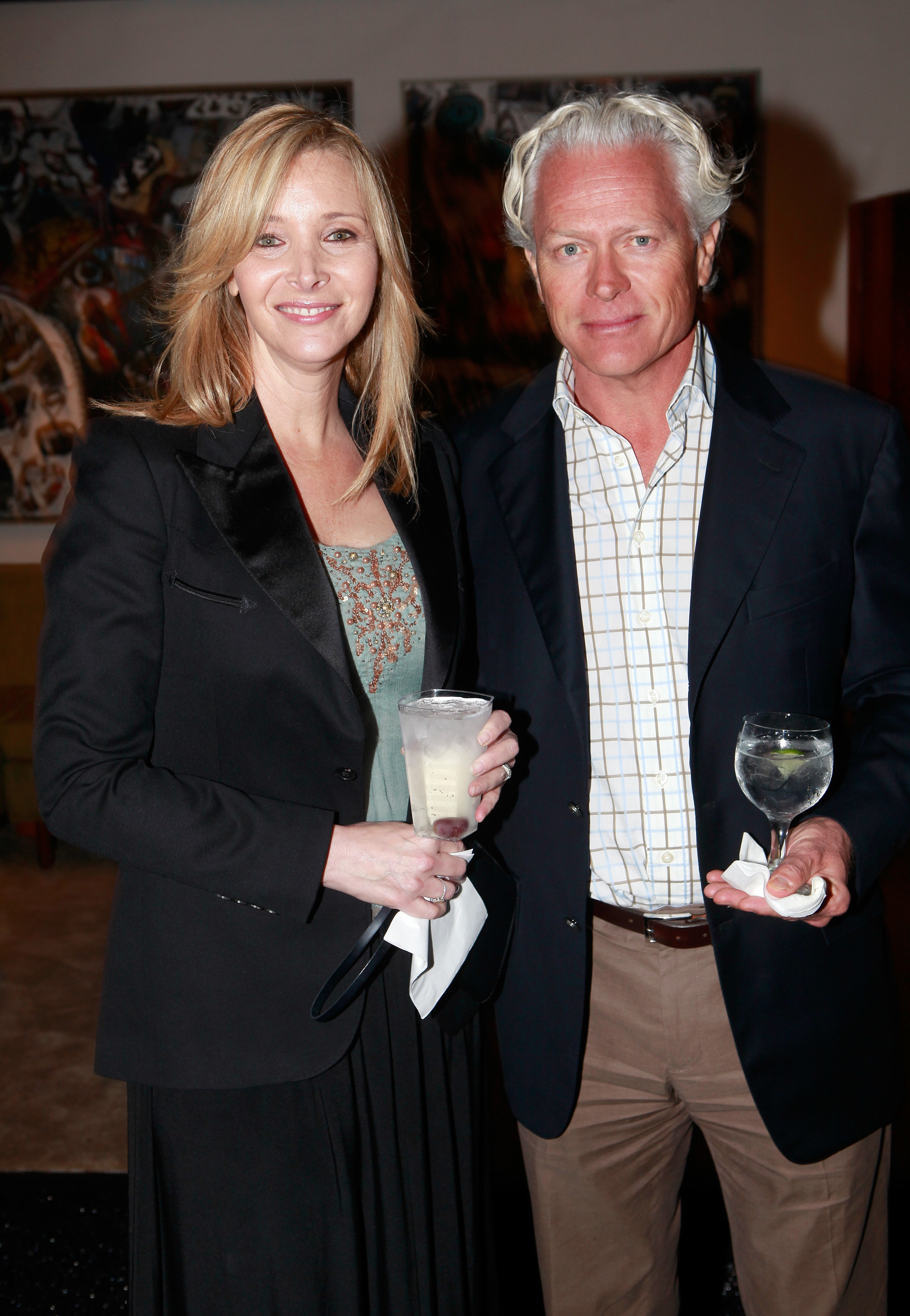 smiling together while holding beverages