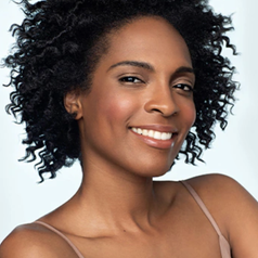 model with shiny curls after using the curl enhancer on their short hair