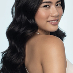 model with smooth waves and curls after using the same curl enhancer for their long hair