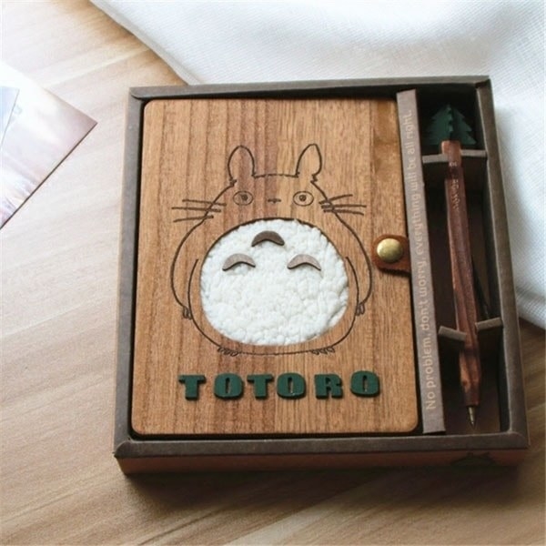 the wooden journal with a plush totoro on the front