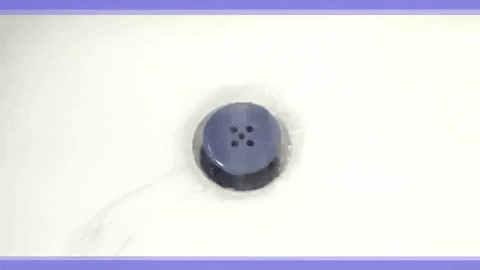 Gif of the TubShroom in a shower drain picking up hairs